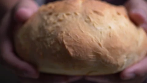 Fresh baked bread in baker hands Stock-Footage 132679400