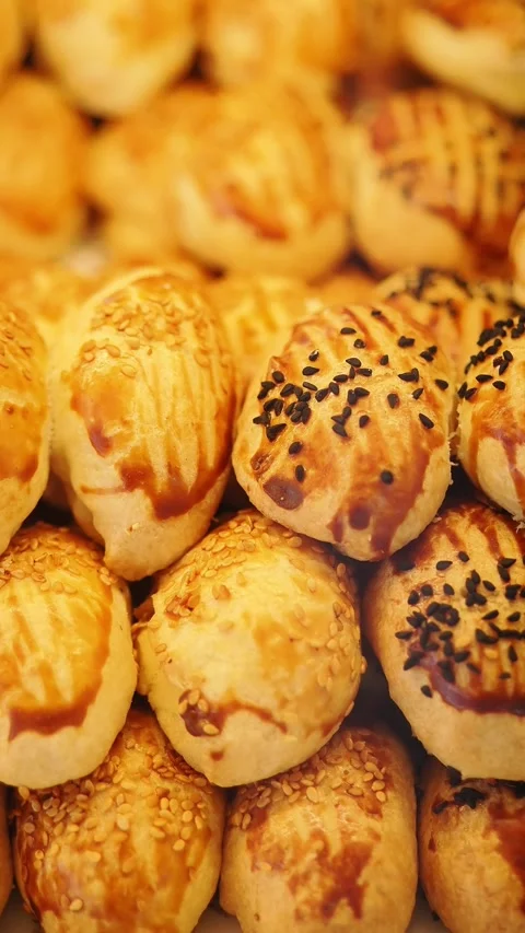 Fresh baked bread on display at local bakery during daytime Stock Footage 347696220