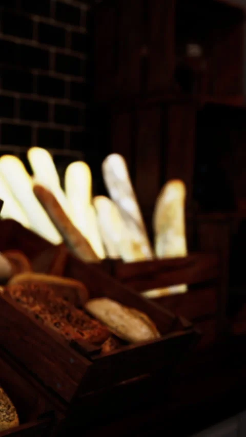 Fresh baked bread displayed at a market stall in the early morning Stock Footage 340633477
