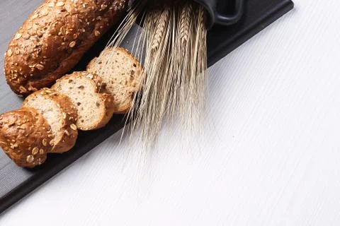 Fresh baked bread with ears of wheat. Wheat yellow. Breakfast is Stock Photos