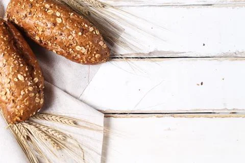 Fresh baked bread with ears of wheat. Wheat yellow. Breakfast is Stock Photos
