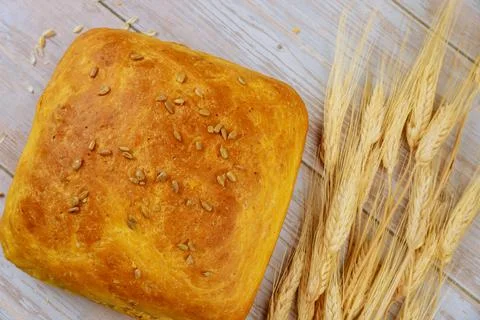 Fresh baked bread with ears of wheat. Stock Photos