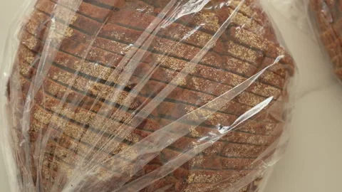 Fresh Baked Bread Loaf Wrapped in Plastic Packaging Stock Footage 308375826