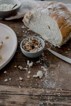 Fresh baked bread with oats on rustic table Stock Photos