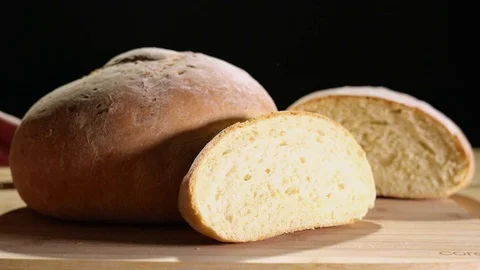 Fresh Baked Bread Pushed Into Frame Against Black Background Stock Footage 82148612