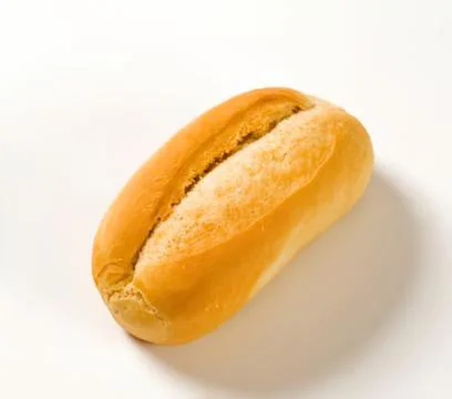 Fresh baked bread roll on white surface Fotos Stock