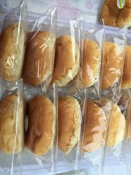 Fresh Baked Bread Rolls Packaged in Plastic Wrappers Stock Photos