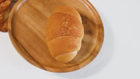 Fresh Baked Bread Rolls Placed on Wooden Plate Stock Footage 337996965