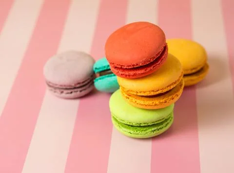 Fresh baked colored macaroon cookies macarons, macarons on a white plate clos Stock Photos