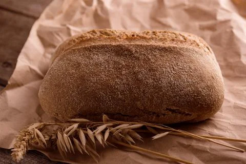 Fresh baked crispy bread on an old rustic wooden table. French bread. Bakery Stock Photos