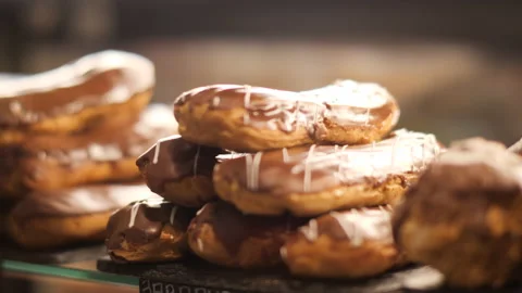 Fresh baked eclair on counter in confectionery. Various desserts in fridge Stock-Footage 229374998