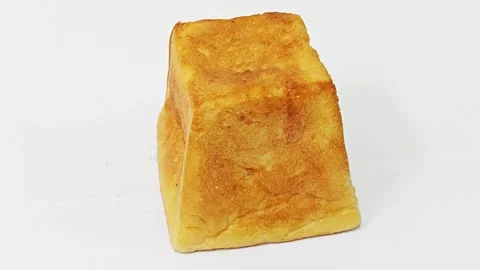 Fresh baked golden cube bread isolated on white background. Stock Footage 343126636