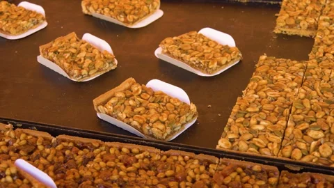 Fresh baked nut bars on display table Stock Footage 334656749