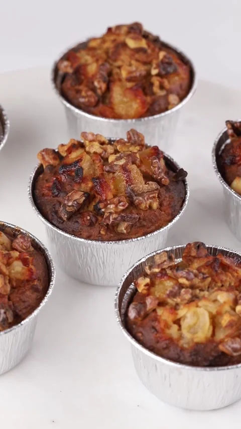 Fresh baked oat muffins rotation in the foil cups Stock Footage 290804707