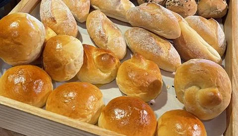 Fresh Baked soft bread rolls and hard bread rolls. Warm Fresh Buttery Rolls. Stock Photos