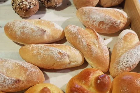 Fresh Baked soft bread rolls and hard bread rolls. Warm Fresh Buttery Rolls. Stock Photos