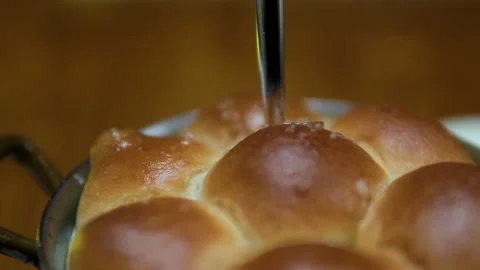Fresh baked yellow bread or pie in black round frying pan rotating close-up Stock Footage 302089532