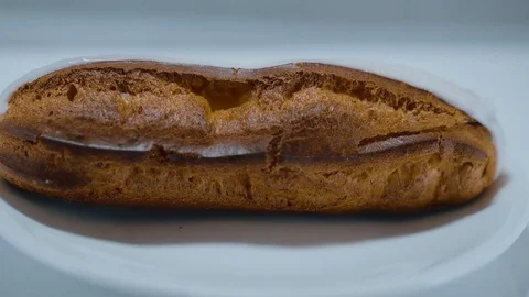Fresh from the bakery - French Eclair pastry Stock Footage 71747213