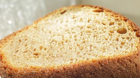 Fresh bakery loaf of bread on white background. Close up slow panorama. Stock Footage 50582204