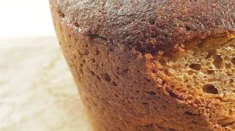Fresh bakery loaf of bread on white background. Close up slow panorama. Stock Footage 50582271