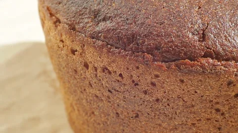 Fresh bakery loaf of bread on white background. Close up slow panorama. Stock Footage 50582306