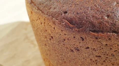 Fresh bakery loaf of bread on white background. Close up slow panorama. Stock Footage 50582359
