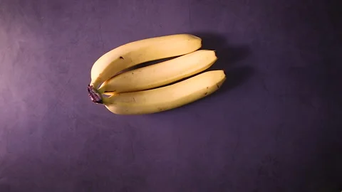 Fresh bananas falling on the table. slow motion flat lay Видео 154754223