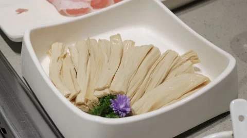Fresh bean curd stick ready to cook in hotpot, Sichuan Hotpot Style Stock Footage 183442212