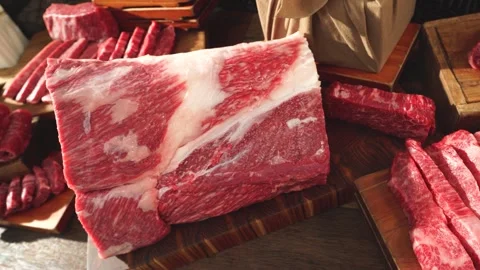 Fresh Beef and Pork Cuts Slowly Sliding Across Table Surface Stock Footage 335257009