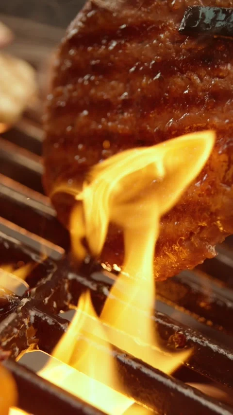Fresh beef burger patty grilling on hot BBQ charcoal flame for cooking deli.. Stock Footage 337599313