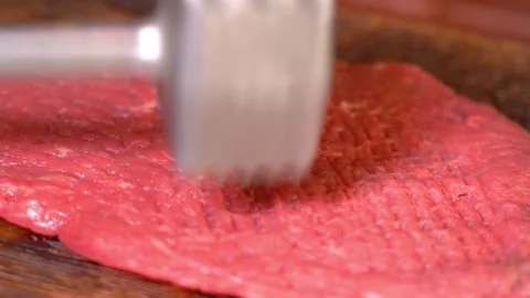 Fresh beef meat for cooking, beaten off with a kitchen hammer Stock Footage 249732631