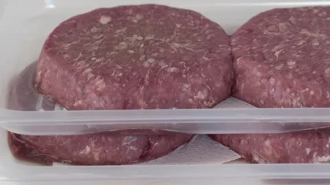 Fresh beef patties arranged in container for cooking and food service concept Video stock 333773350