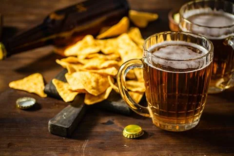 Fresh beer with corn chips. Stock Photos