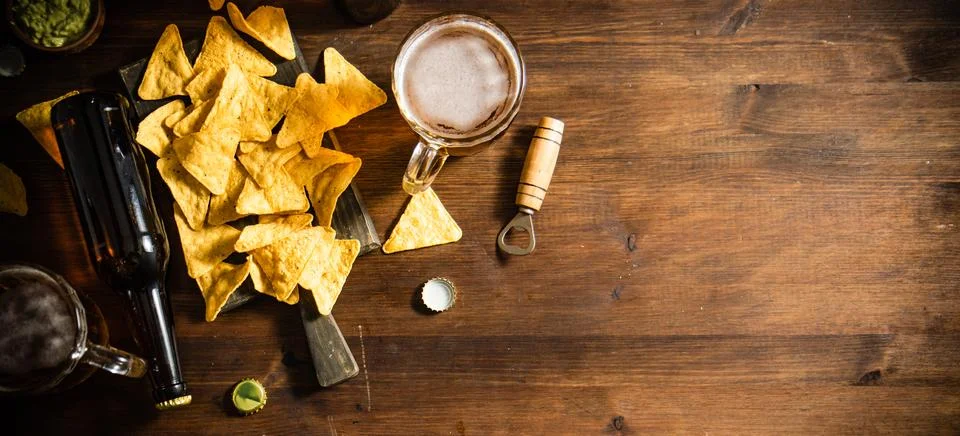 Fresh beer with corn chips. Stock Photos