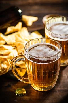 Fresh beer with corn chips. Stock Photos