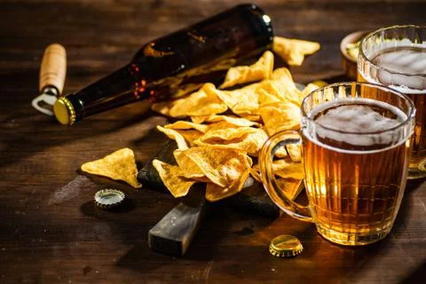 Fresh beer with corn chips. Stock Photos