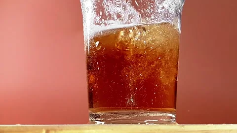 Fresh beer with drops on gold background Stock Footage 260483345