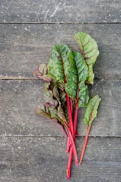 Fresh beetroot leaves chard on the surface of an old wooden table Stock Photos