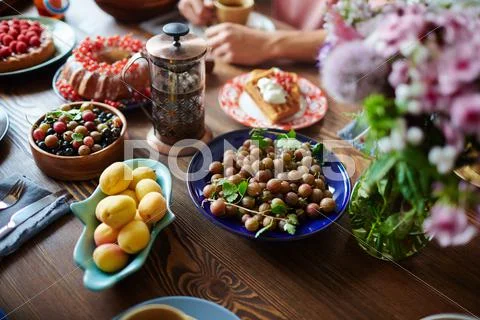 Fresh berries, apricots and other food on served table Stock Photos