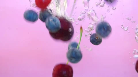 Fresh berries fall into the water Stock Footage 135381130
