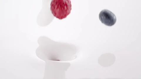 Fresh berries falling into the flow of milk Stock Footage 171888308