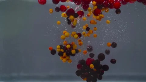 Fresh berries orange with red fall on a grey background into the water Stock Footage 166696683