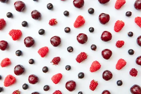 Fresh berries of raspberry, cherry and currant on a white background. Fruit Foto stock
