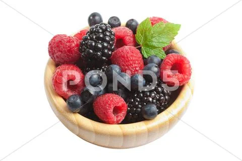 Fresh berries in wood bowl isolated Stock Photos