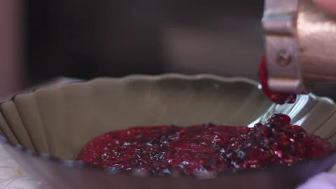 Fresh Berry Puree Dropping from a Manual Meat Grinder into a Glass Bowl Stock Footage 339650065