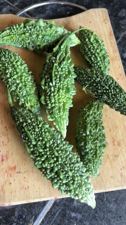 Fresh Bitter Gourd Close-Up in Kitchen Setting — Portrait Vegetable View Видео 321127431