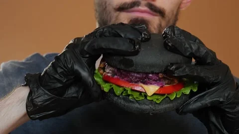 Fresh black burger on a black background. Close-up. Stock Footage 160570973