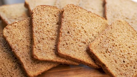 Fresh Black Rye Bread, Sliced, Close-up, Isolated, Rotation. Background of Slice Stock Footage 154243236