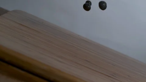 Fresh blackberries bouncing over tilt wooden surface in slow motion Stock Footage 100006681