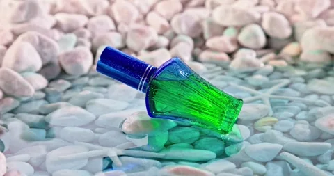Fresh blue perfume in environment of white stones and sea. Stock-Footage 336020756